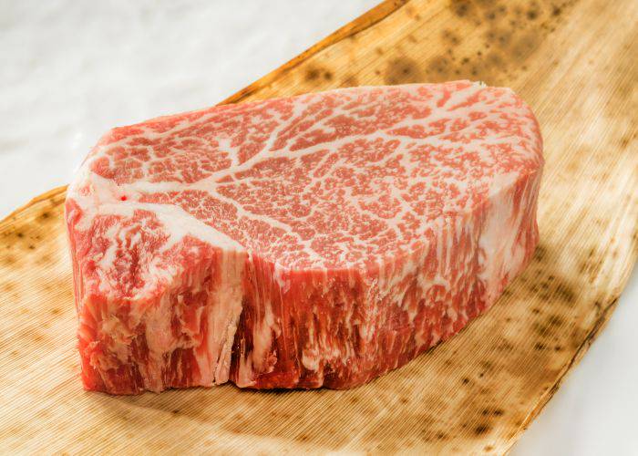 A thick slab of wagyu beef, showing off its high-quality marbling.